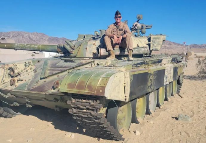 Jonny Sax sitting on a tank